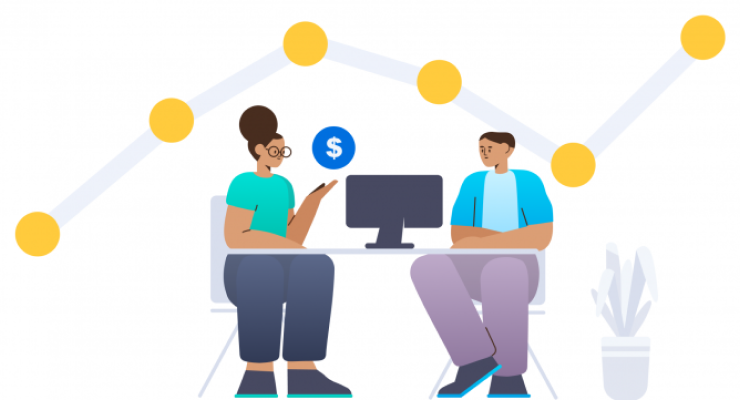 Two sales people talking in front of a computer